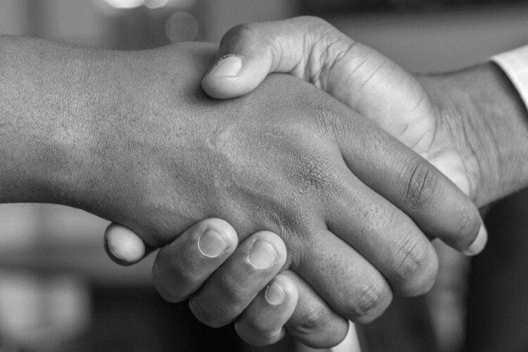 Close-up of 2 people shaking hands