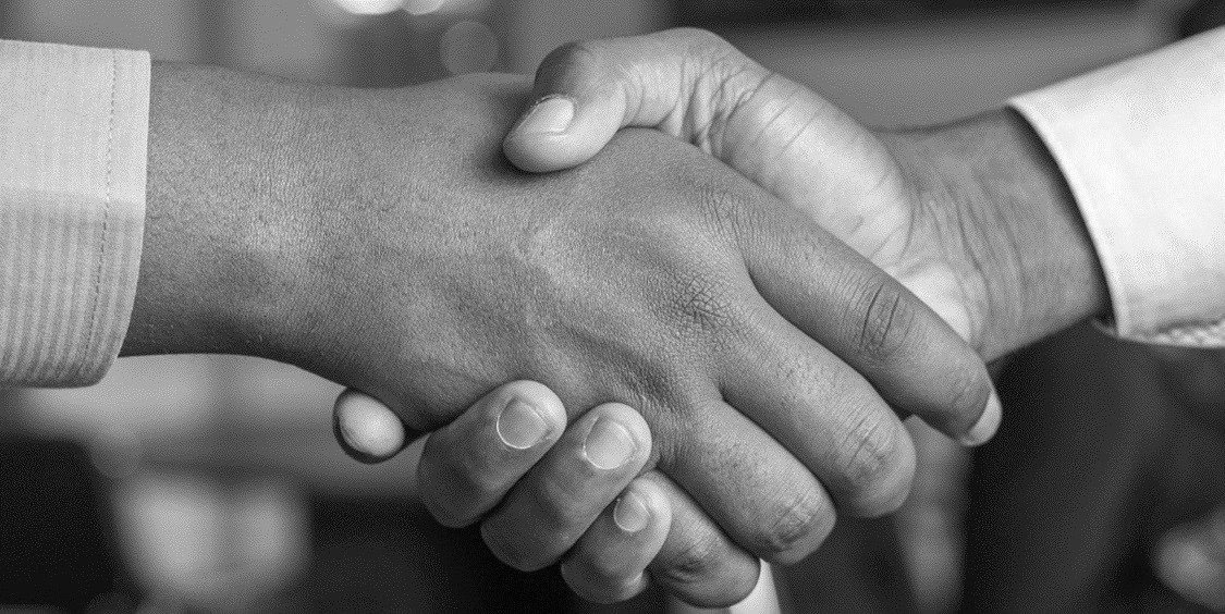 Close-up of 2 people shaking hands