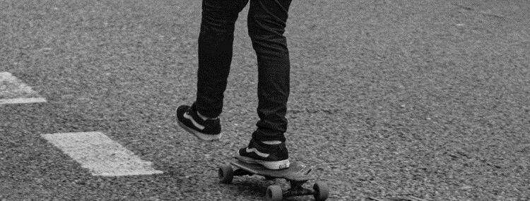 Back view of a young man skateboarding, symbolizing the dynamic journey towards goals with the protection of Term Life Insurance.